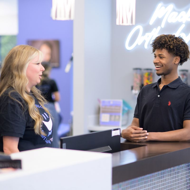 patient talking to front desk during orthodontic visit
