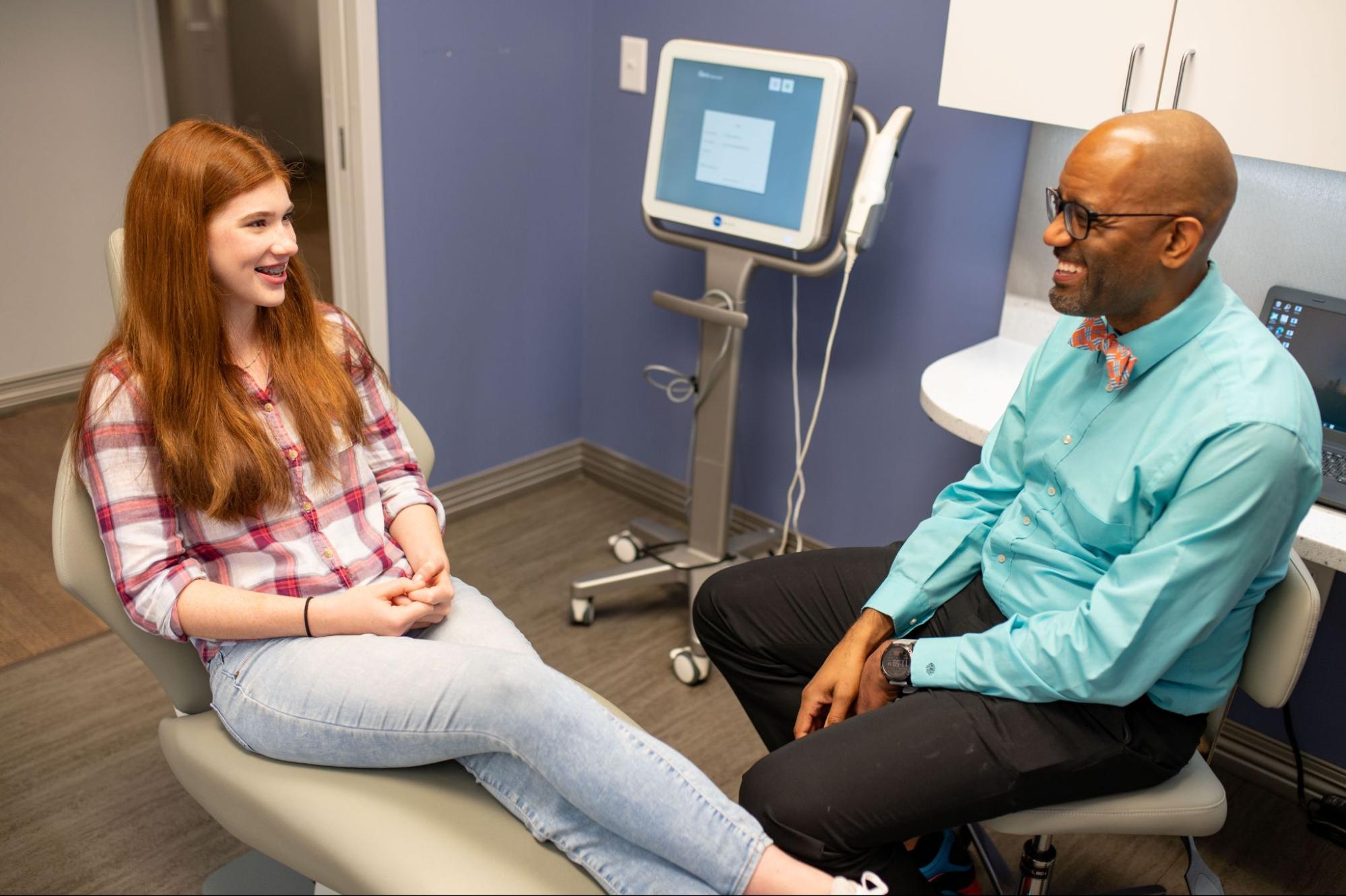 Dr. Mack smiles with an orthodontic patients